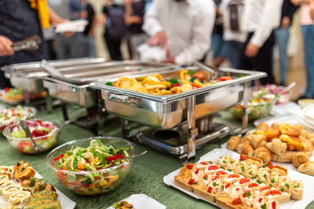close up of buffet table food in chafing dish at celebration event